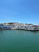 White buildings line the harbor on a sunny day.