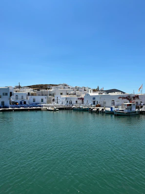 White buildings line the harbor on a sunny day.