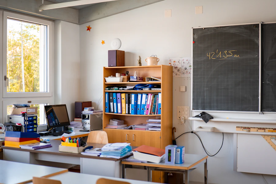 Empty classroom with chalkboard and school supplies