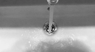 Water flows from the faucet into the sink
