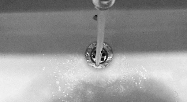 Water flows from the faucet into the sink
