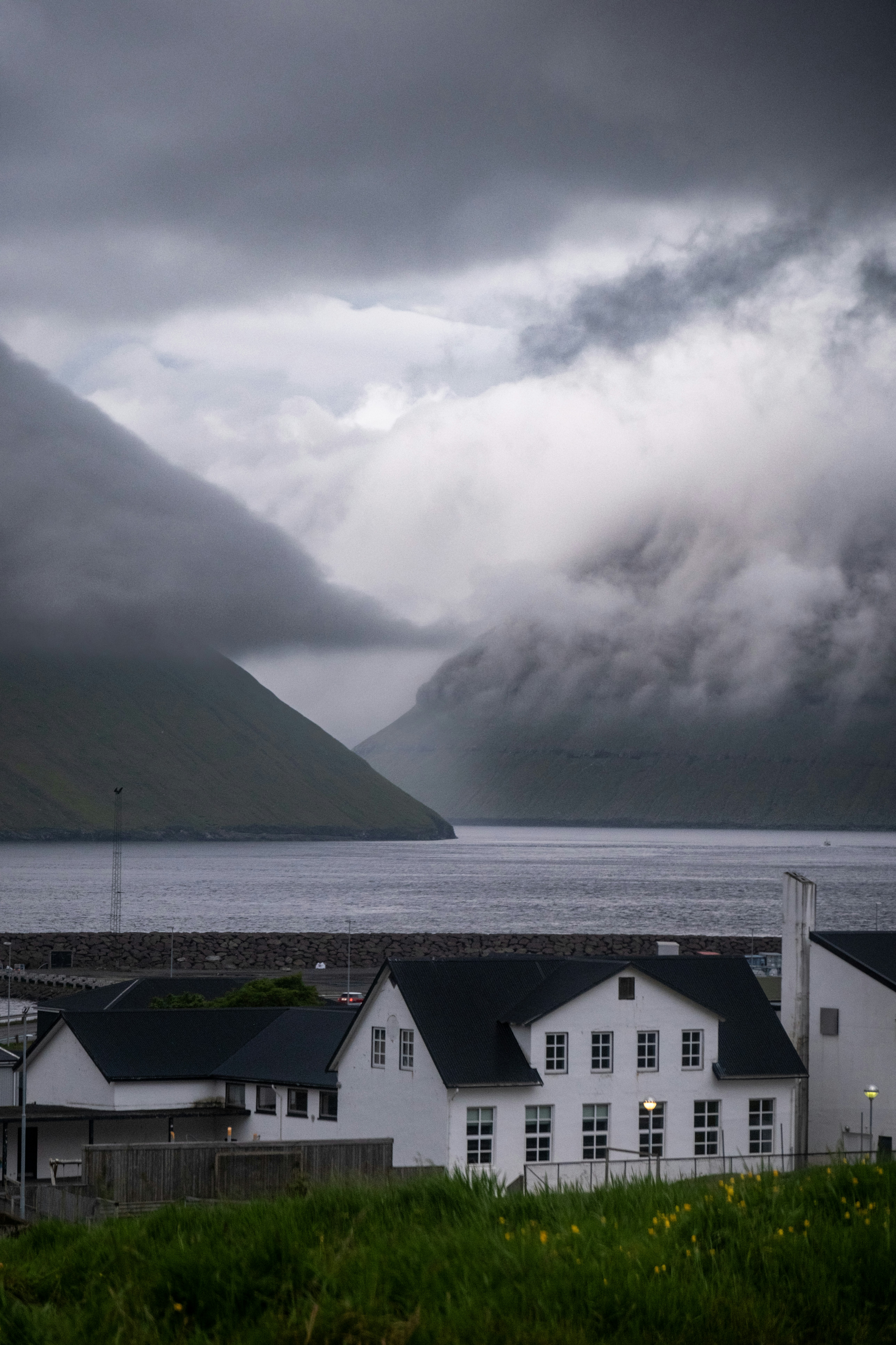 Houses sit beneath a cloudy, dramatic sky.