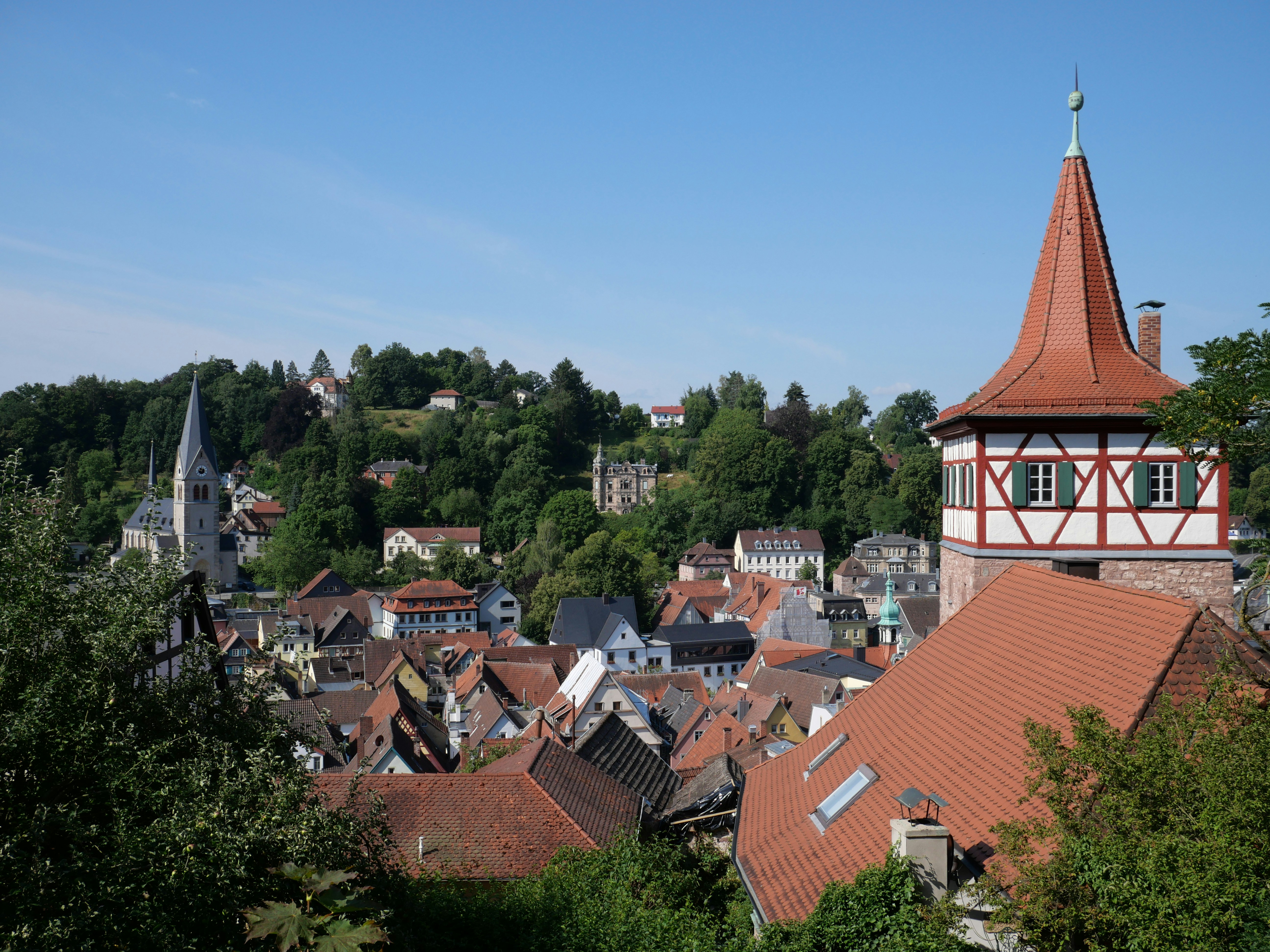 A picturesque european town with orange rooftops.