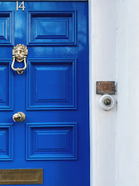 A blue door with a golden knocker.