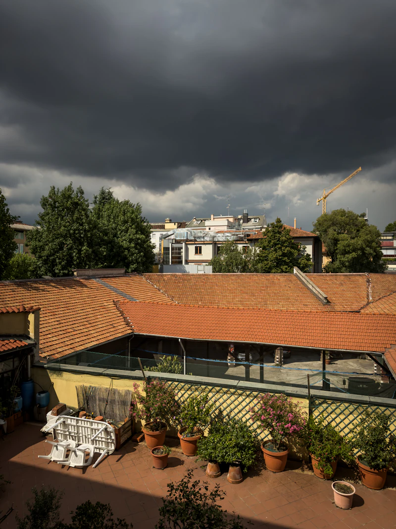 Dark storm clouds over city rooftops
