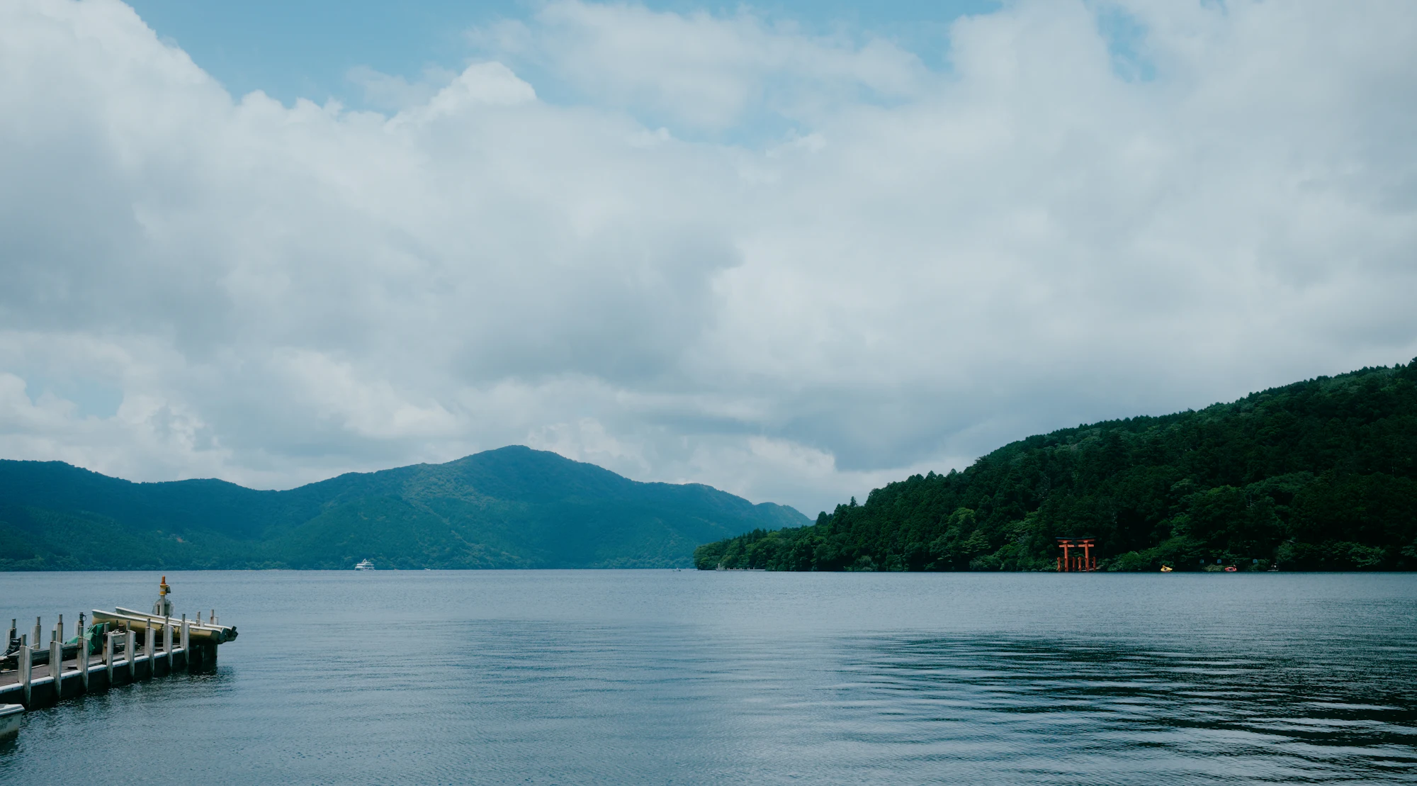 Lake Ashi and forested hills beneath cloudy skies in Hakone.