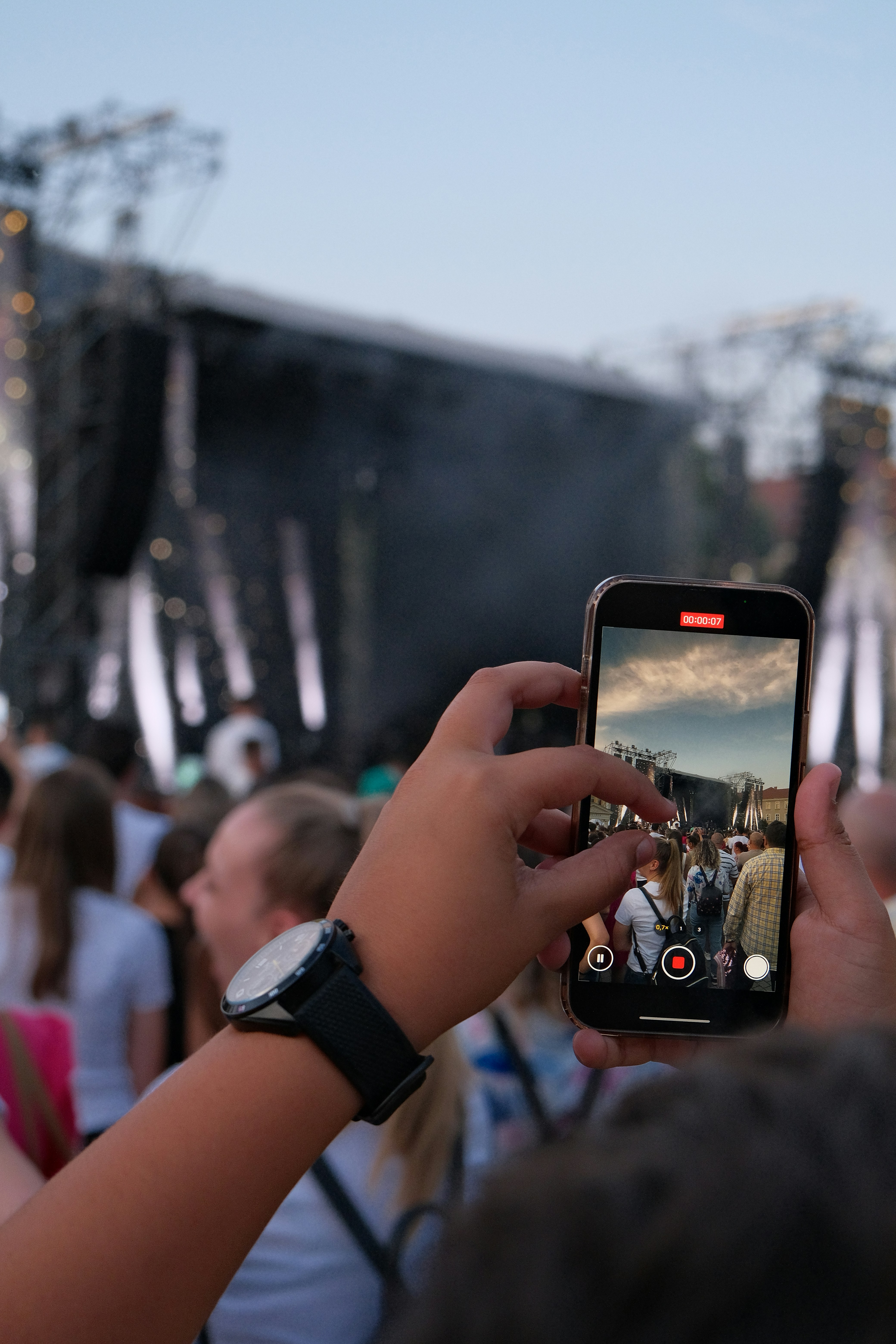 Someone is filming a concert with their phone.