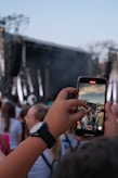 Someone is filming a concert with their phone.