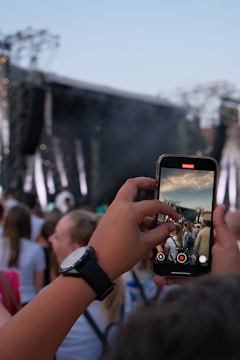 Someone is filming a concert with their phone.