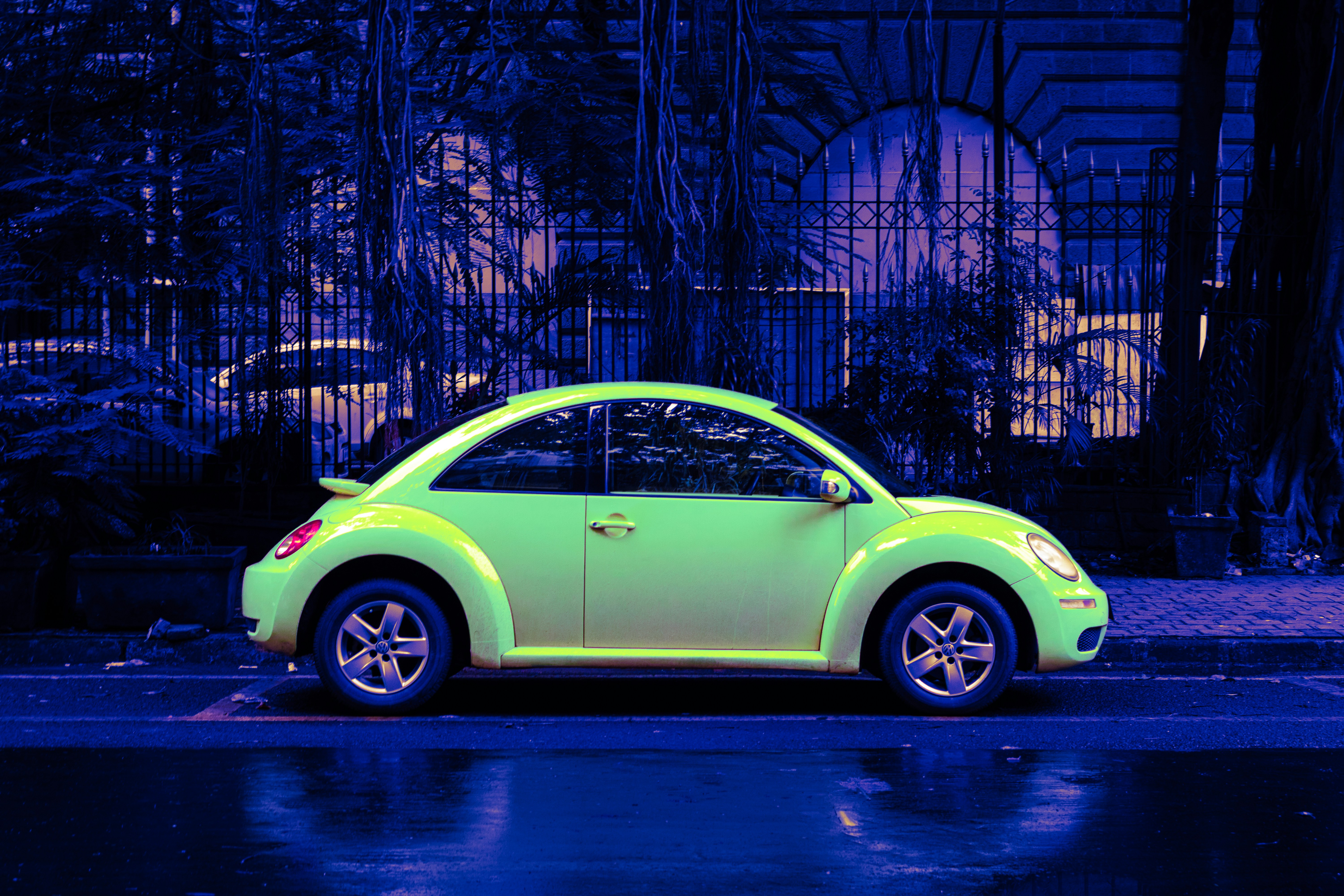Photograph of a modern Volkwagen New Beetle parked on the street at Ballard Estate, Mumbai, India.