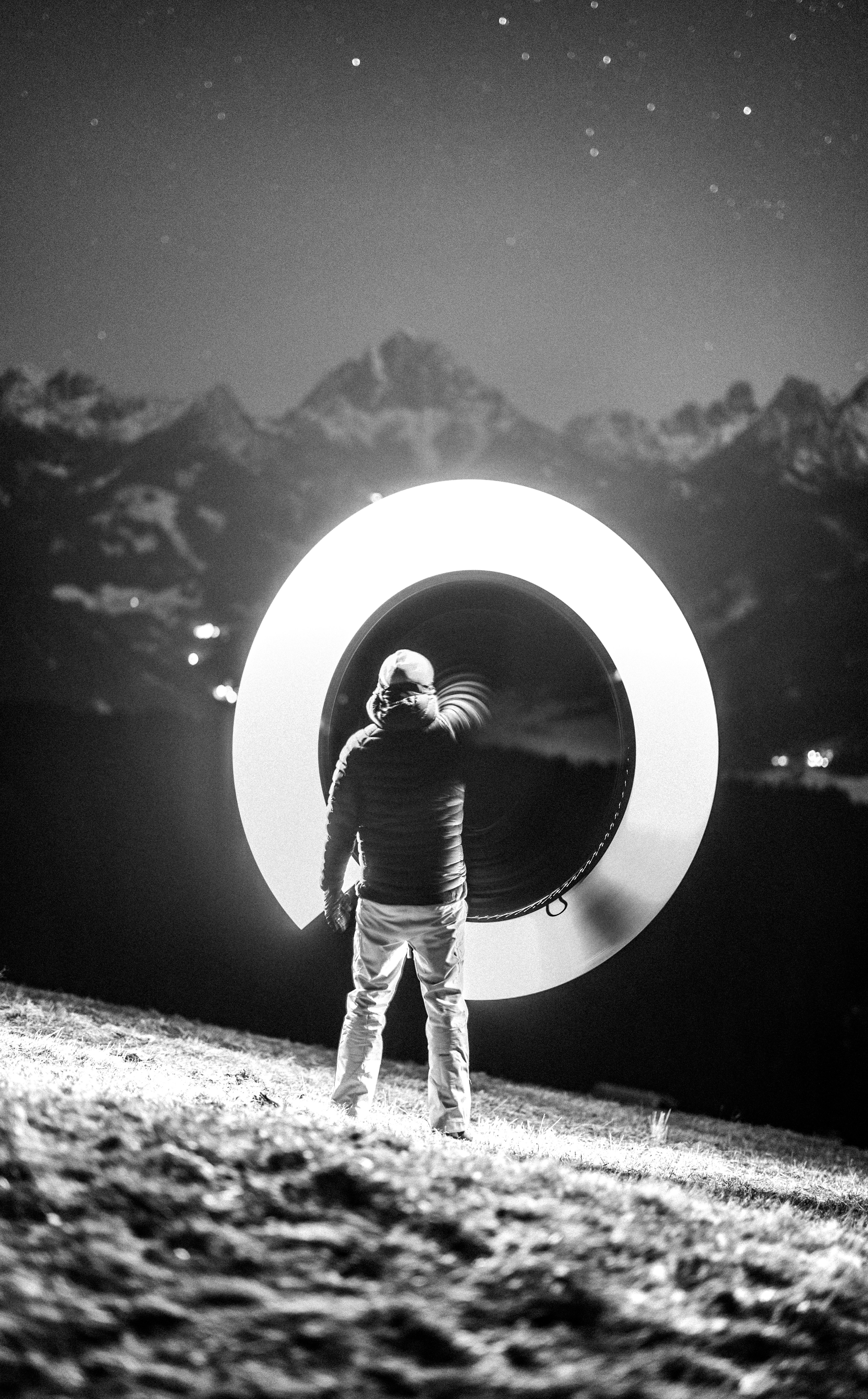 Man makes a light circle with mountain views.