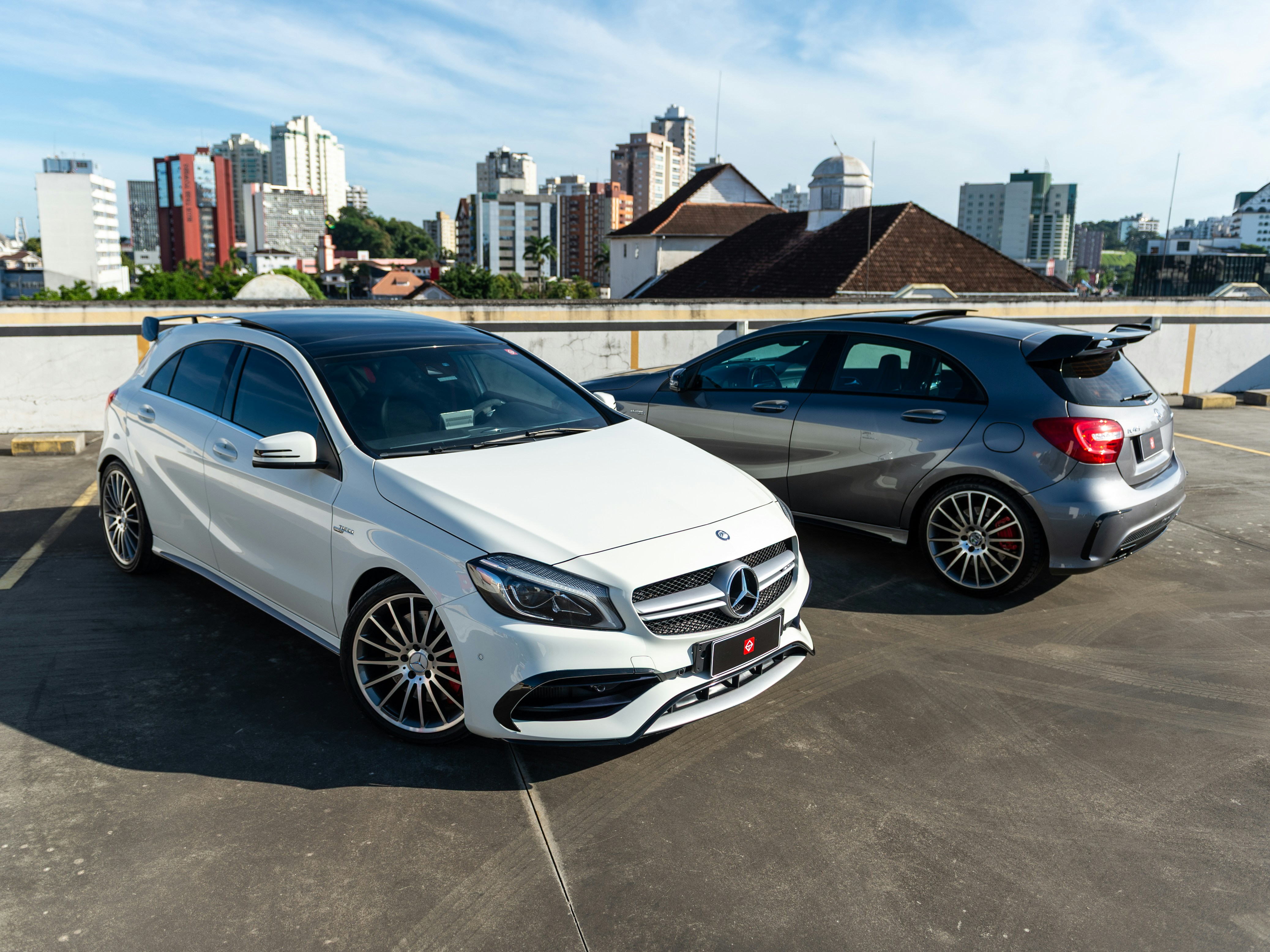Two mercedes-benz a-class cars parked on a rooftop.