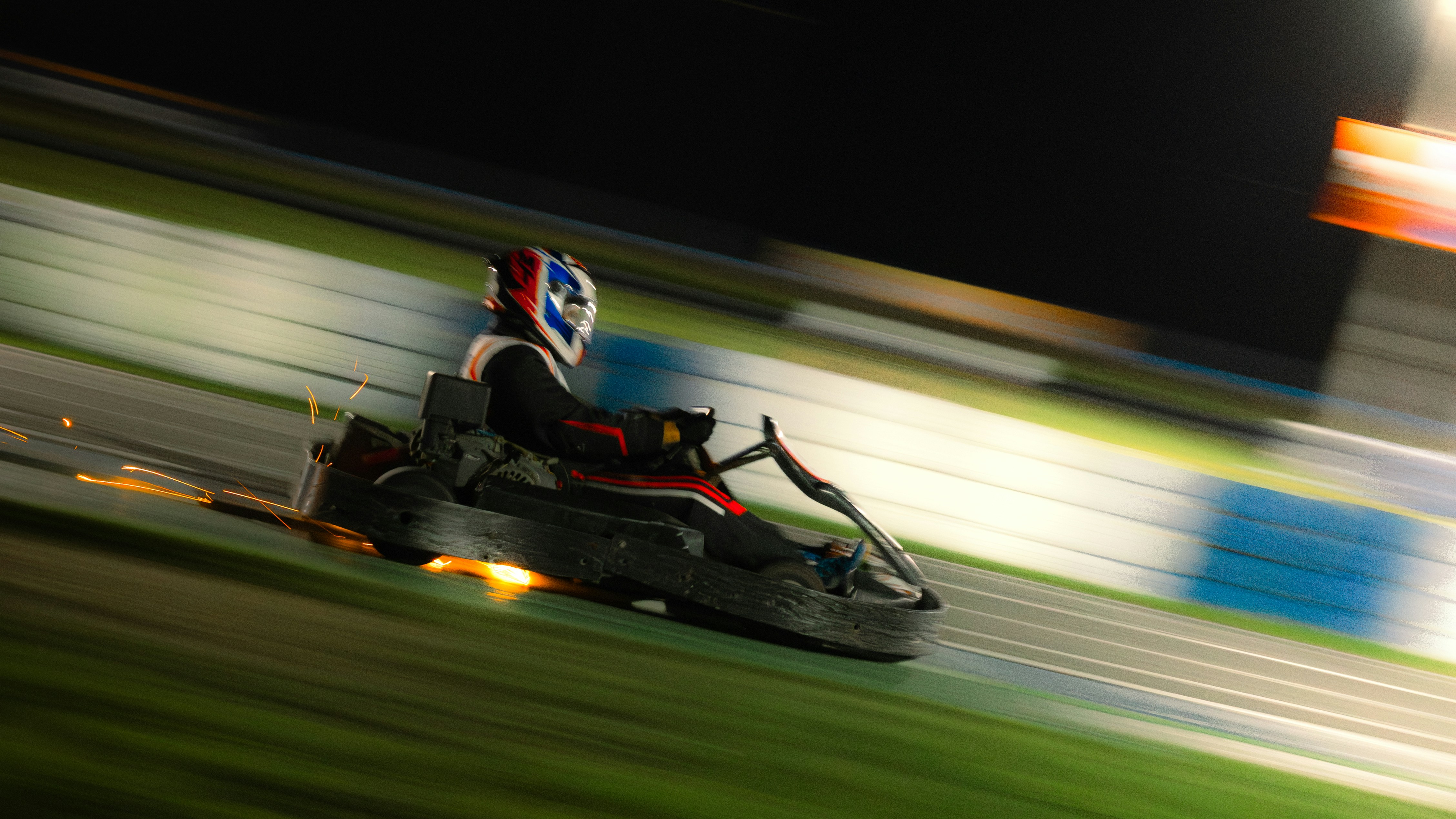 Go-kart racing around a corner at night