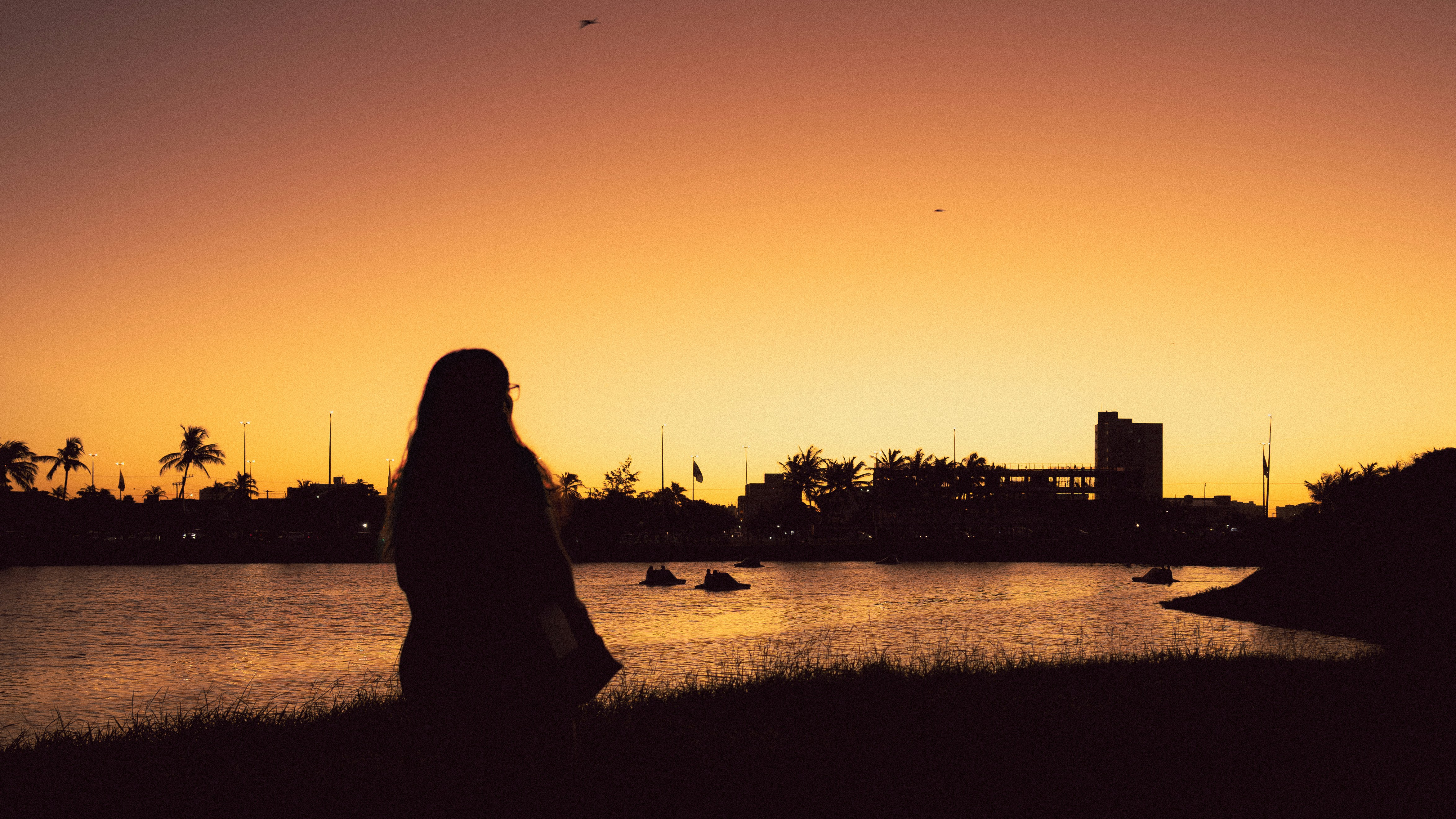 A person silhouetted by a beautiful sunset.