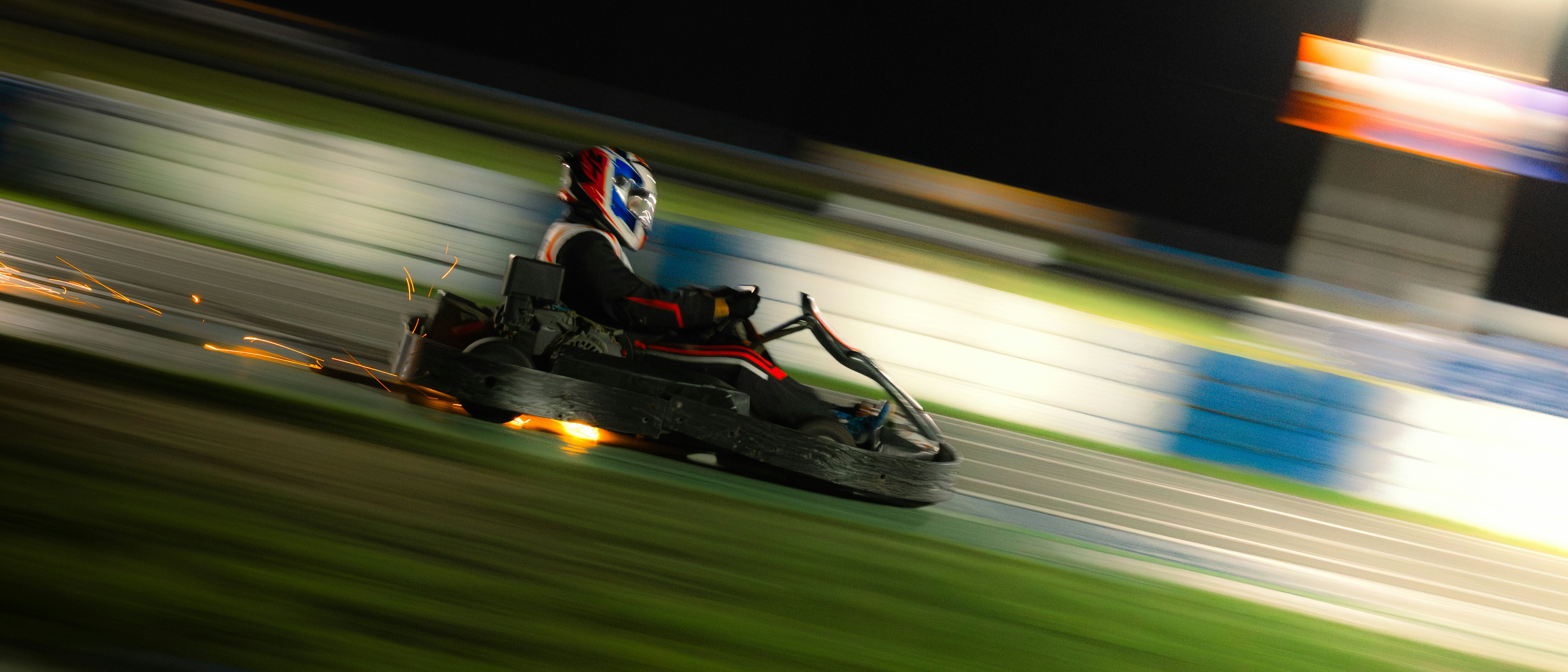 Go-kart racing around a track at night