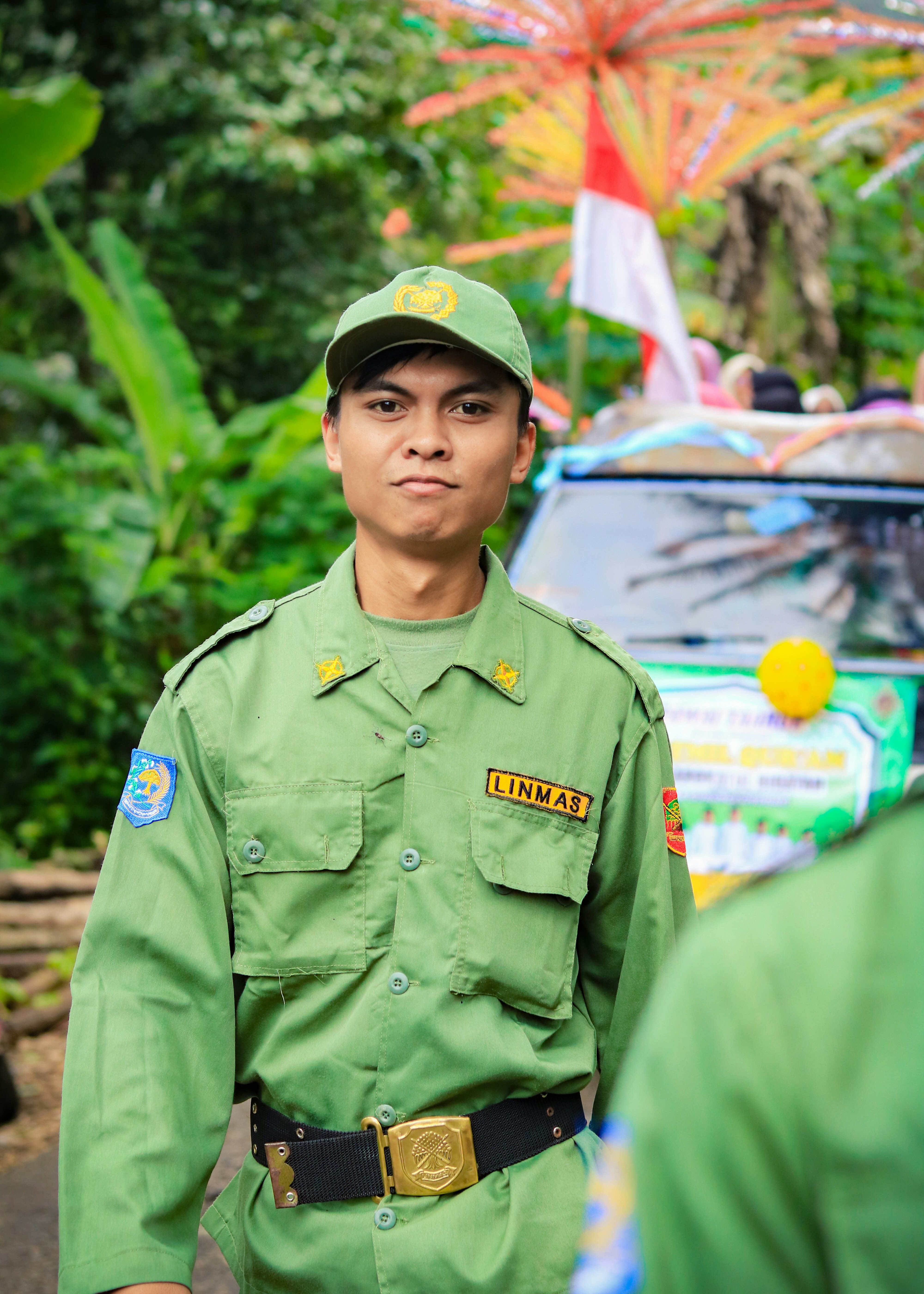 A man in a linmas uniform poses for the photo.