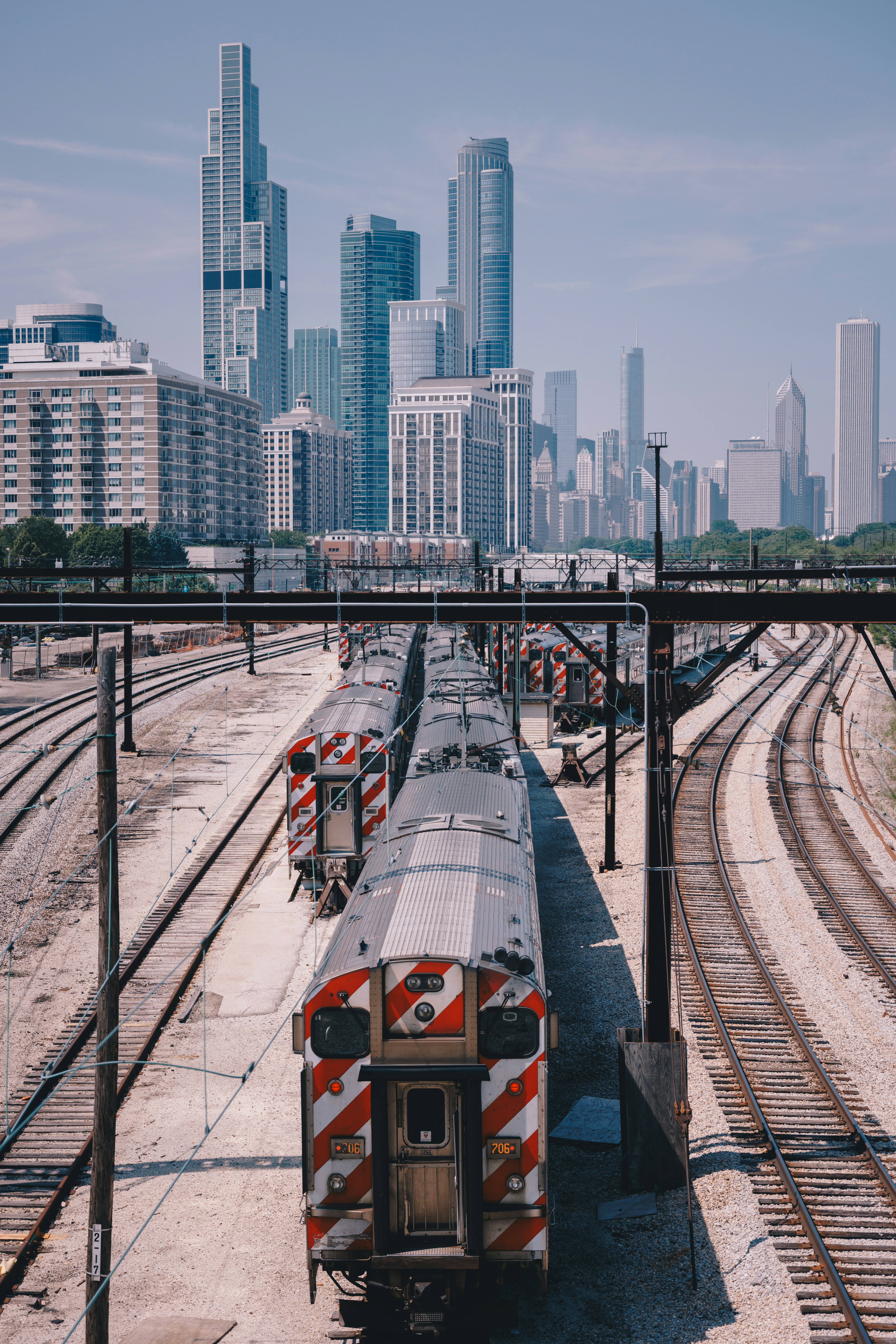 Trains on tracks with a chicago skyline in the background.