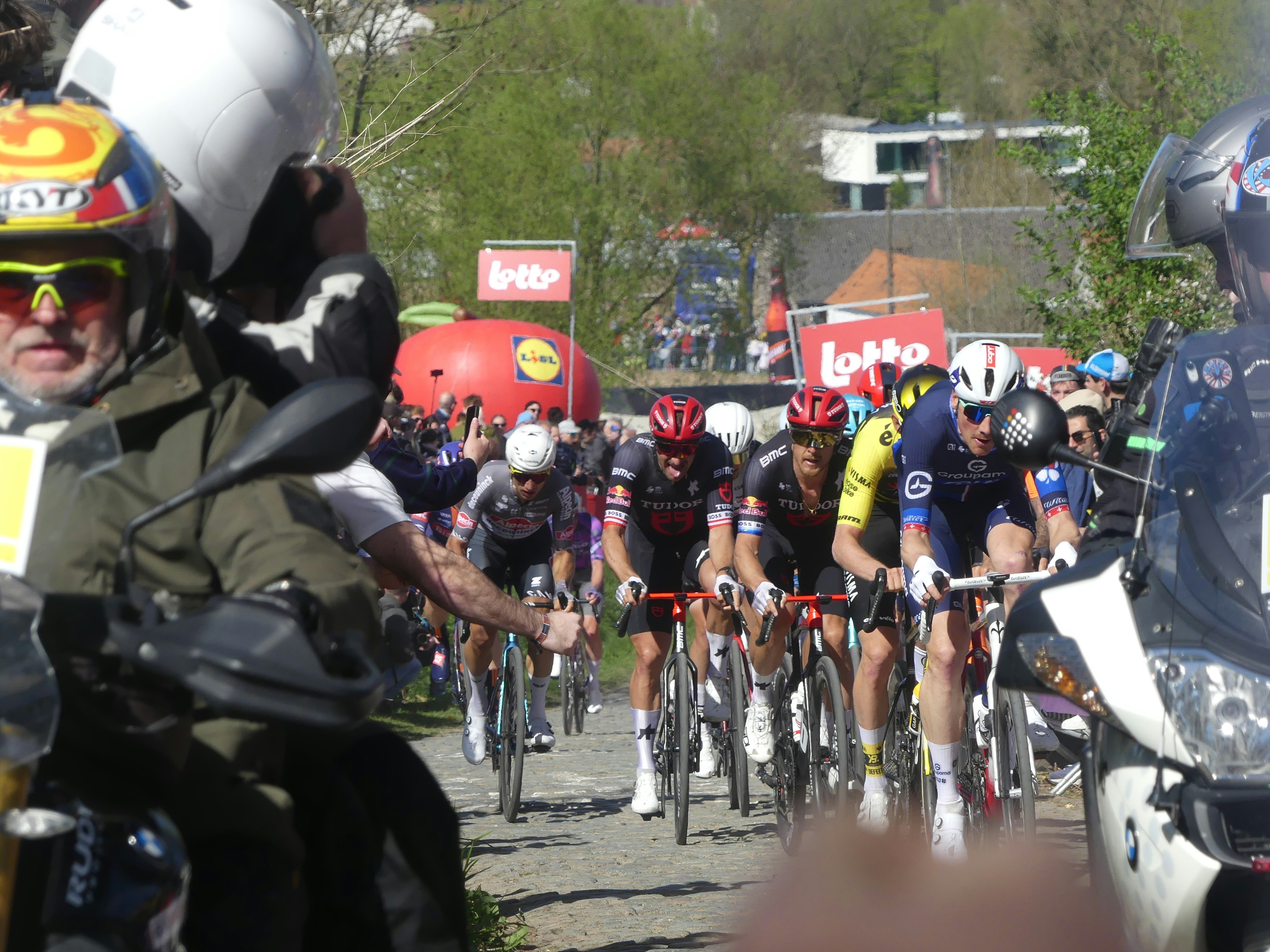 Cyclists race together on a sunny day.