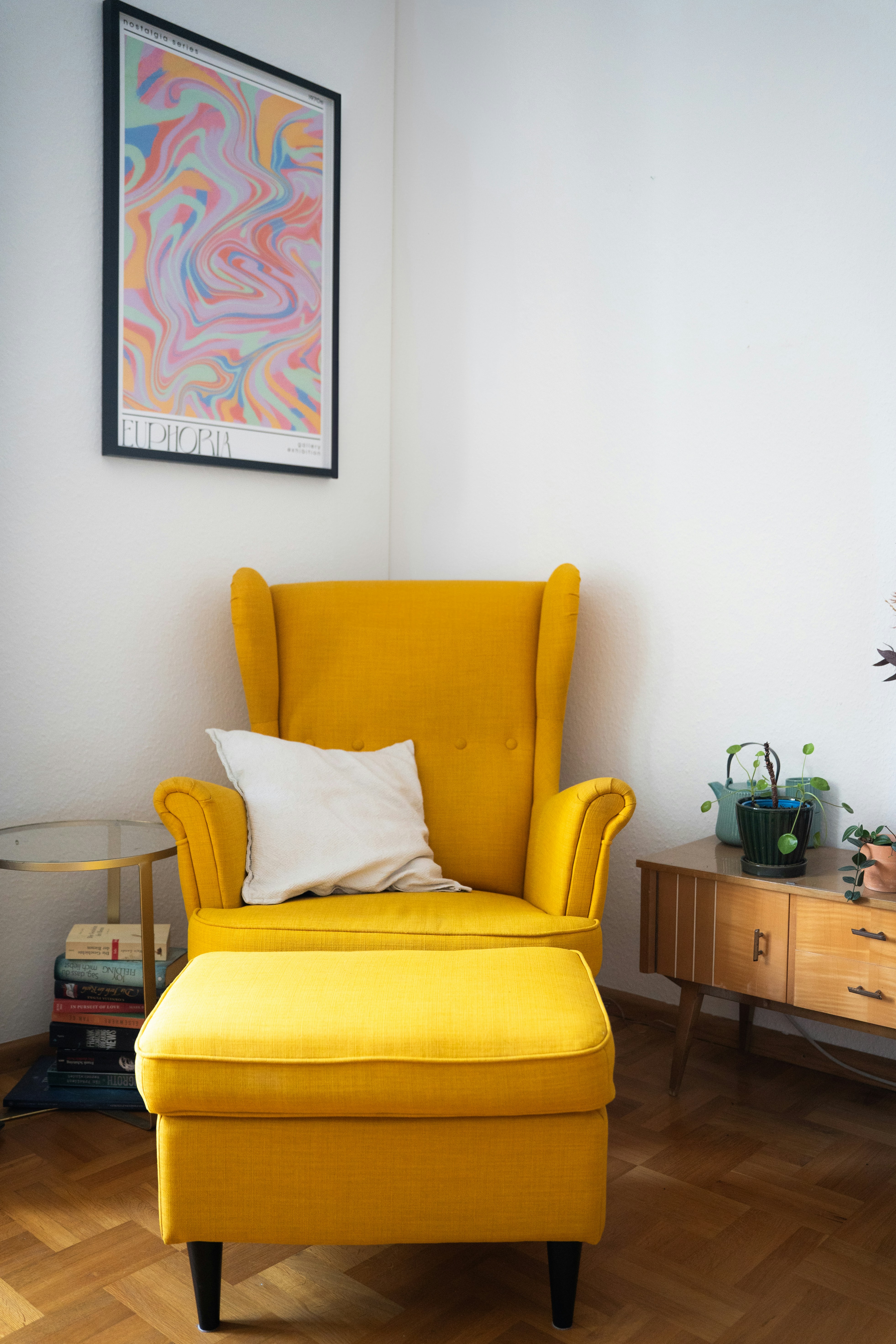 Cozy yellow chair and ottoman in a bright corner.