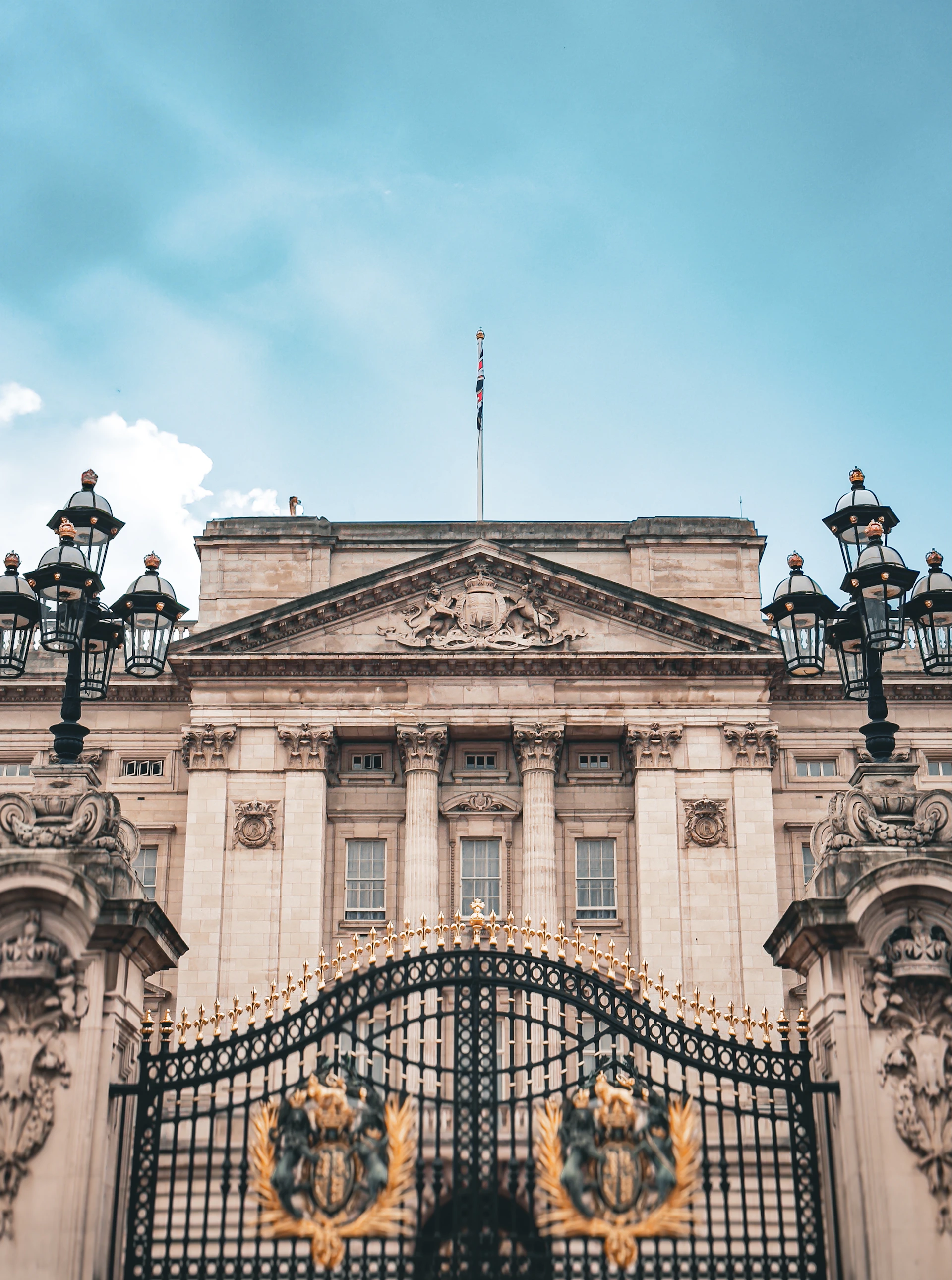 Buckingham palace with gates stands tall.