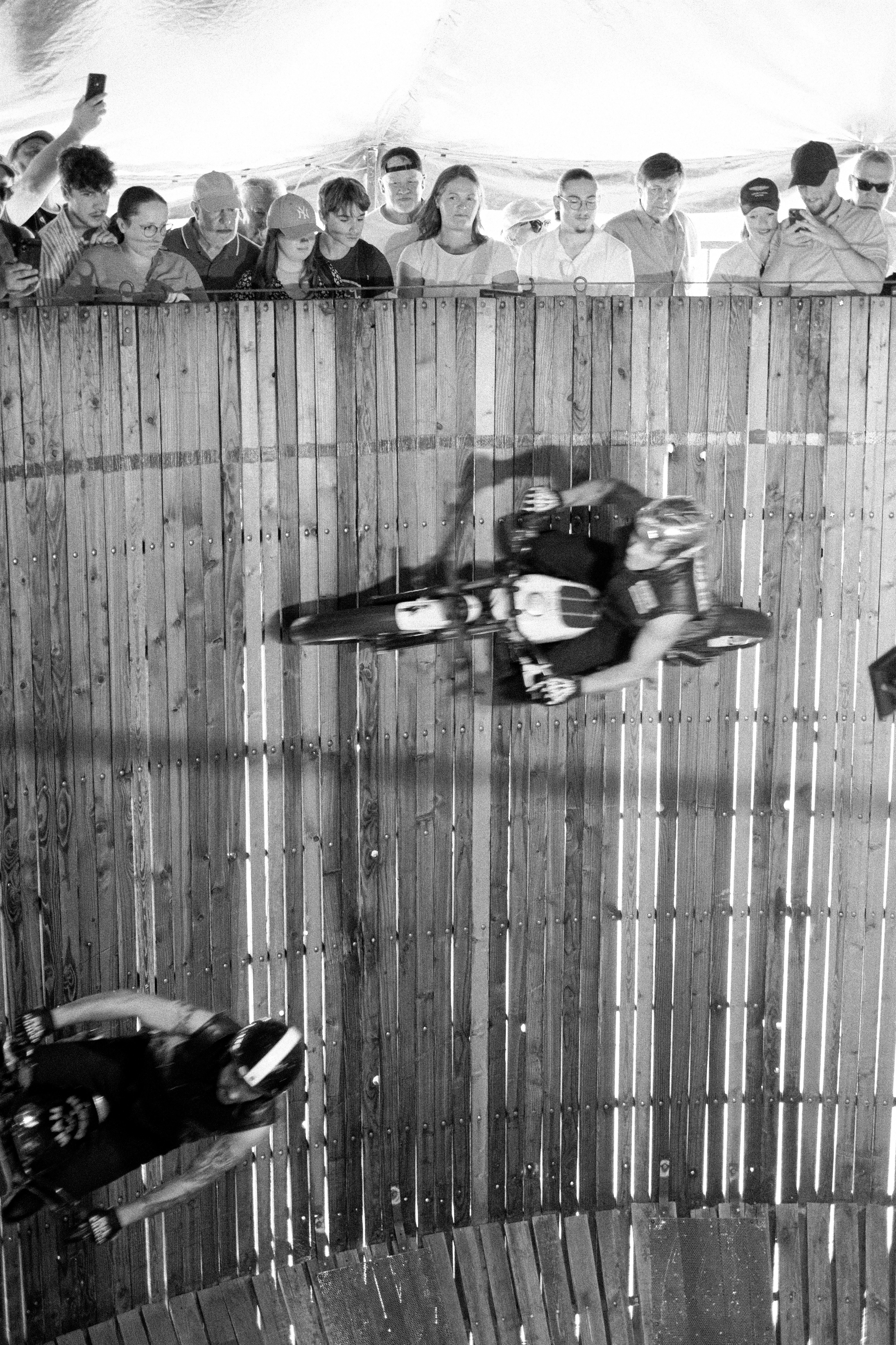 Motorcyclists perform in a wall of death.