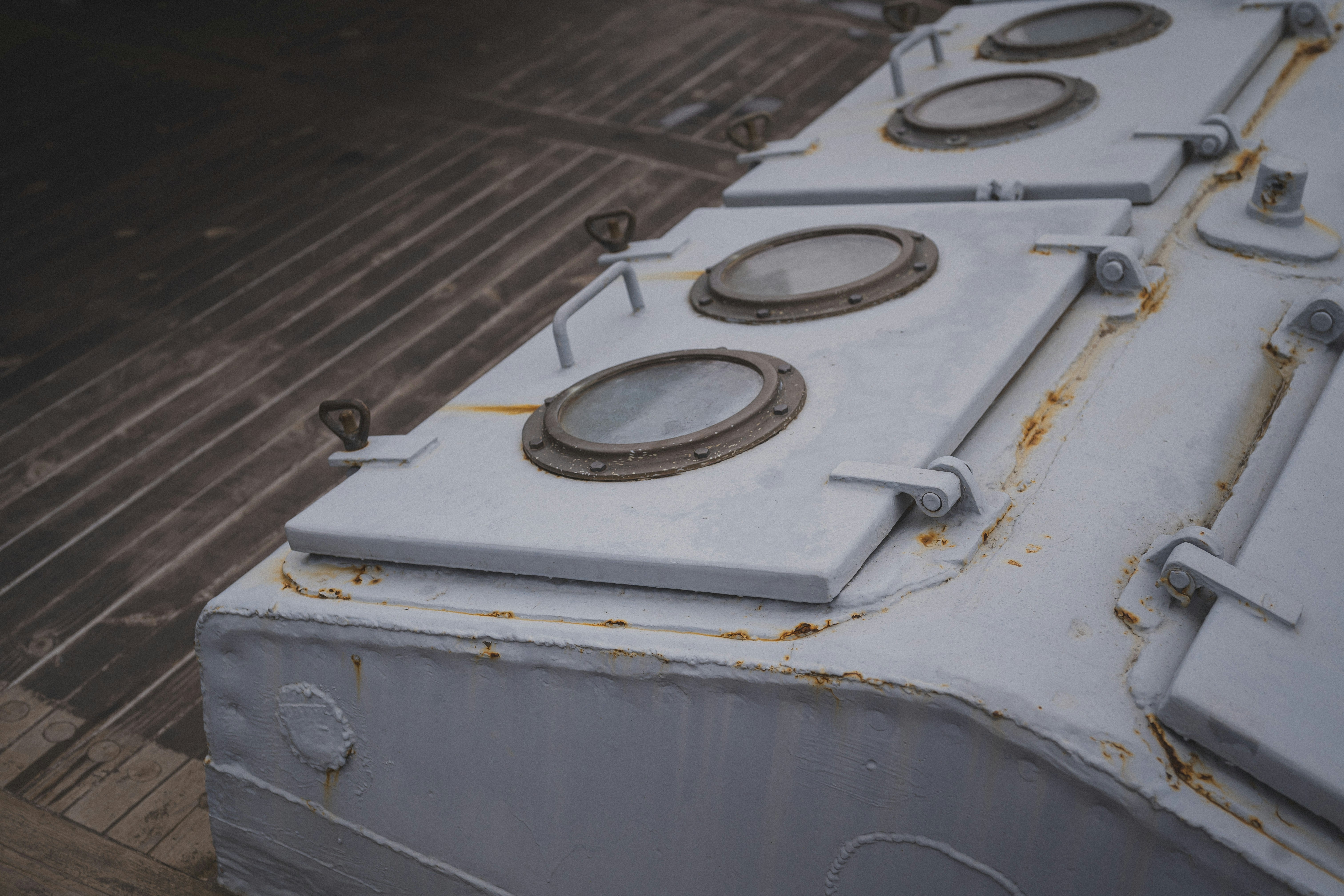 Metal hatches with porthole-shaped windows are seen.