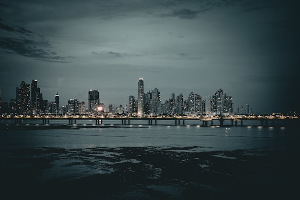 A nighttime cityscape with lights shining brightly.