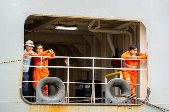 Ship crew members taking a break at the window.