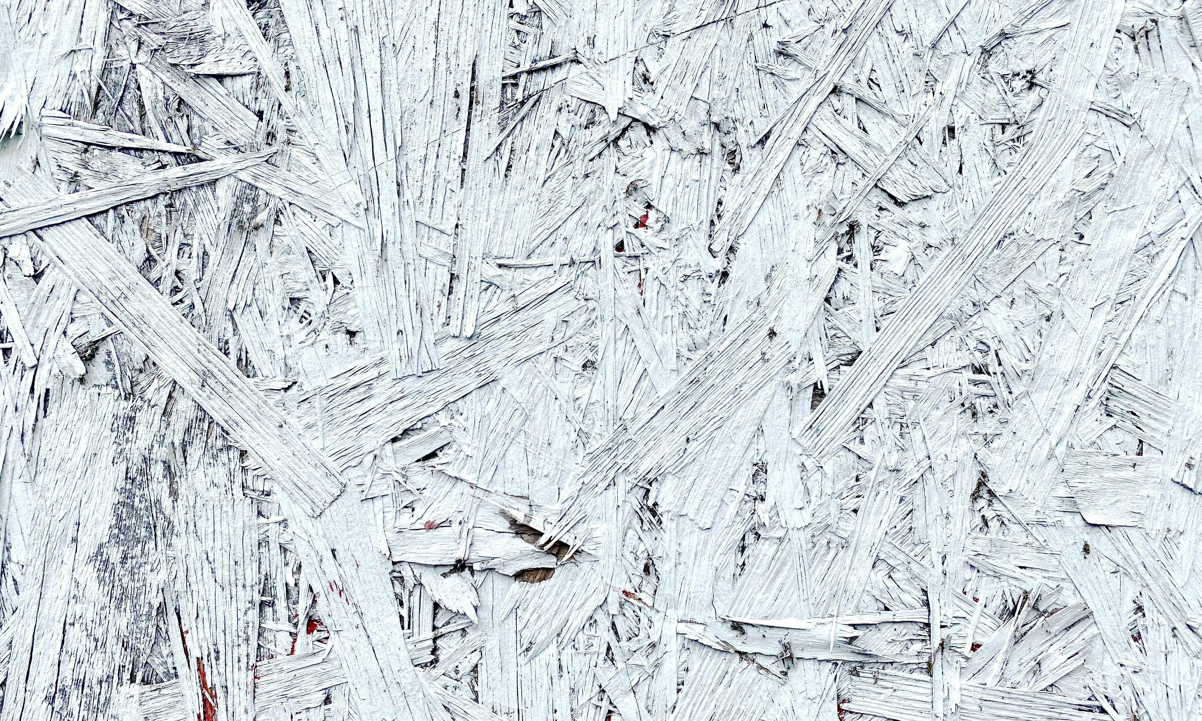 White-painted wood pieces form a textured surface.