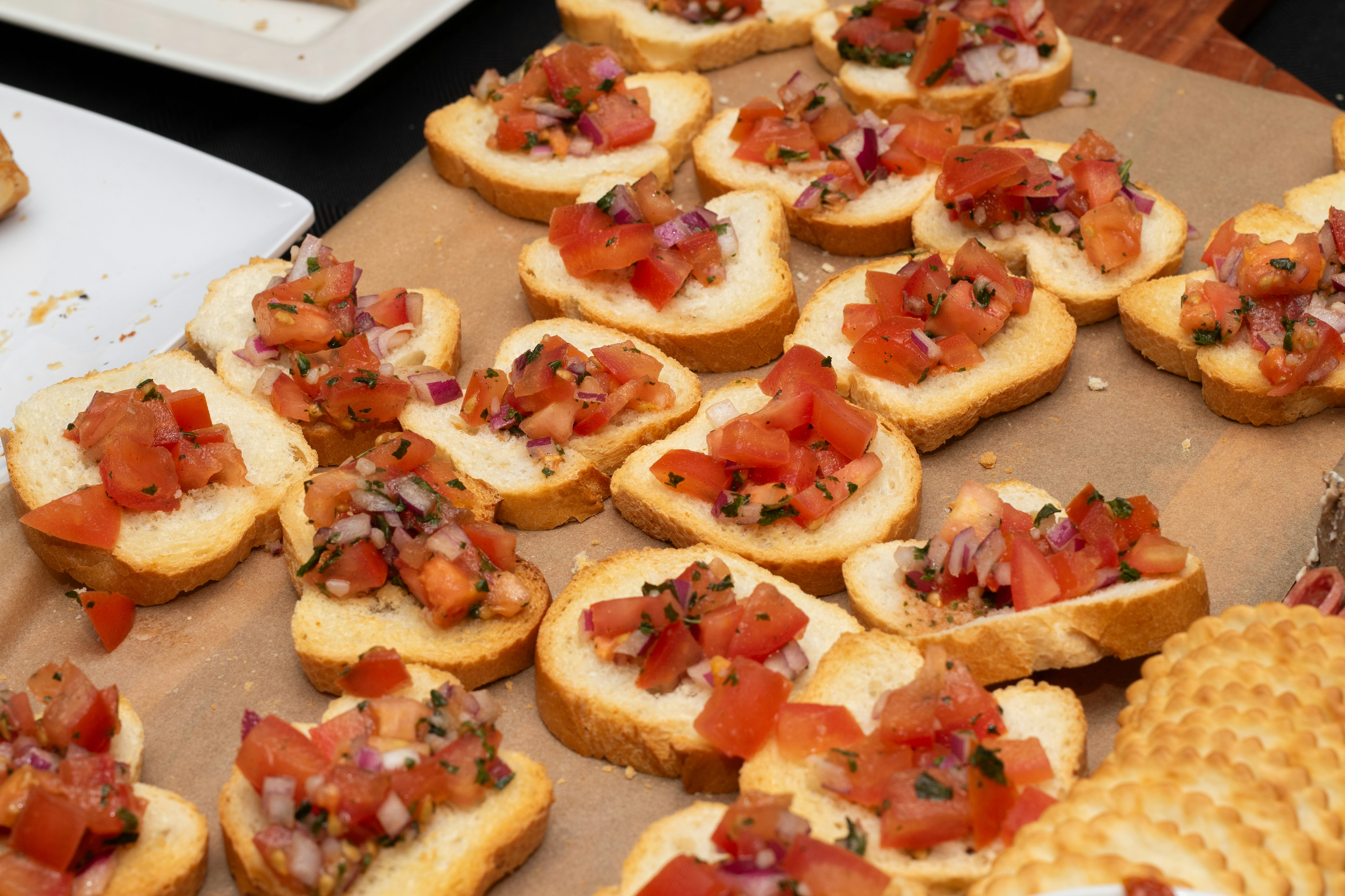Bruschetta appetizer slices on a wooden board.