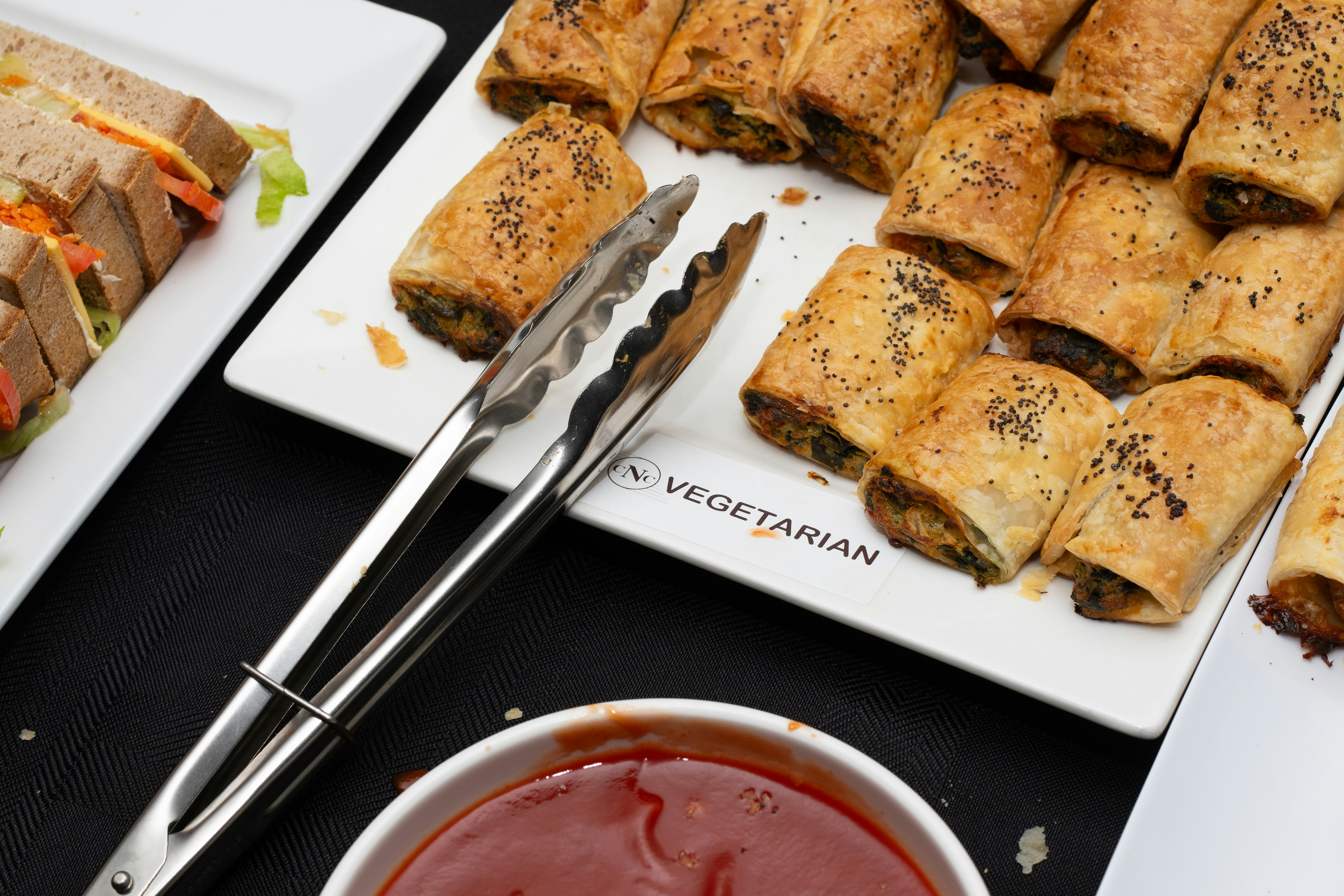 Sausage rolls and snacks are ready to be eaten.