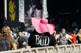 A person in a pink hat at a concert.