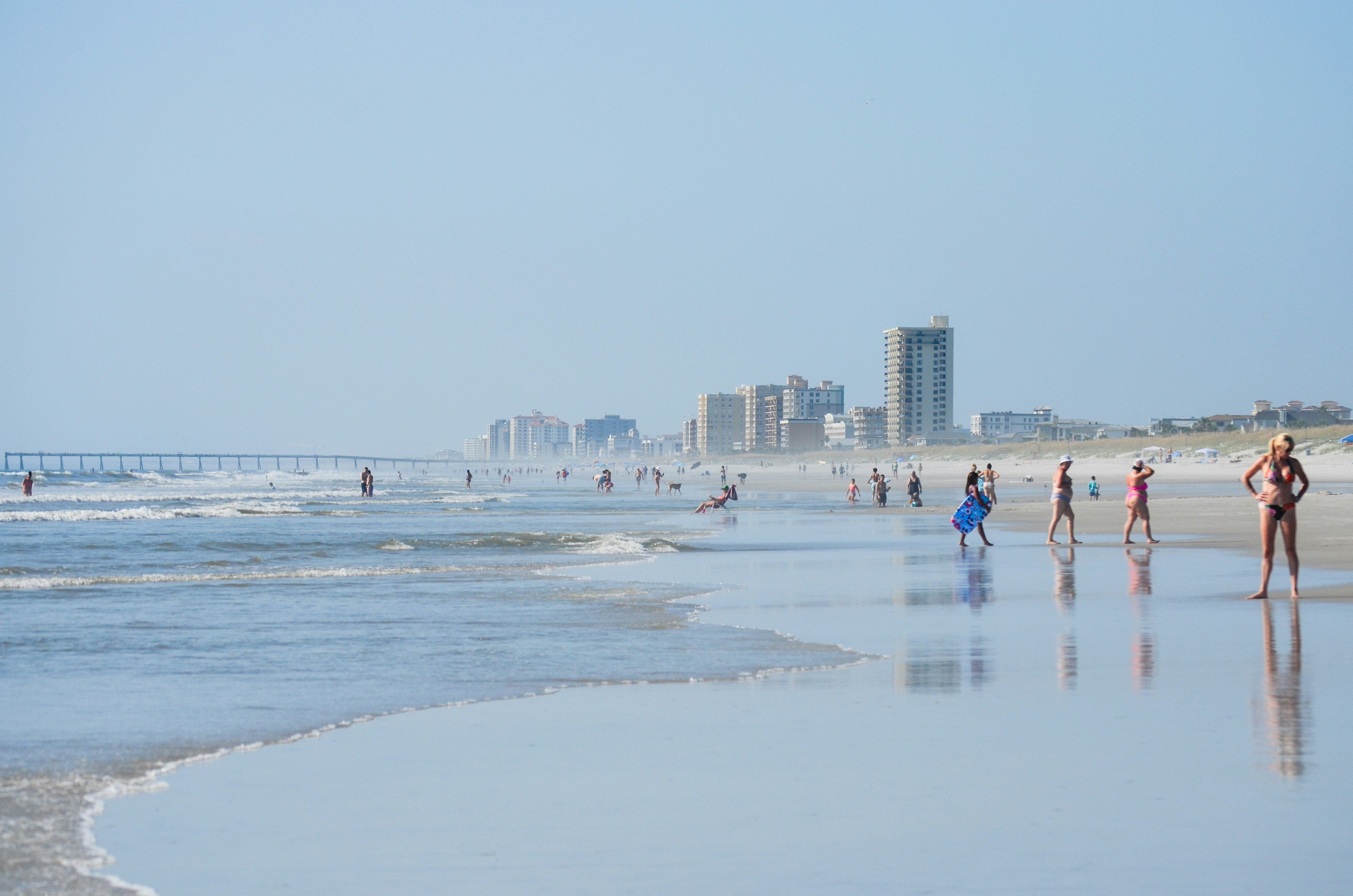 People enjoy a sunny day on the beach.
