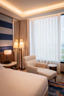 A luxurious hotel room with cozy seating.