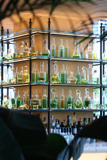 Glass bottles of liquids are displayed on shelves.