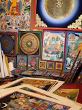 Traditional tibetan paintings and artwork are displayed.