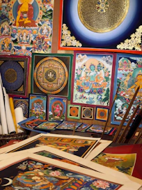 Traditional tibetan paintings and artwork are displayed.