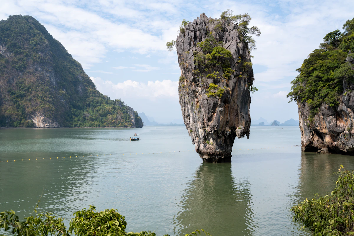 A palm-fringed Thai beach with clear turquoise water