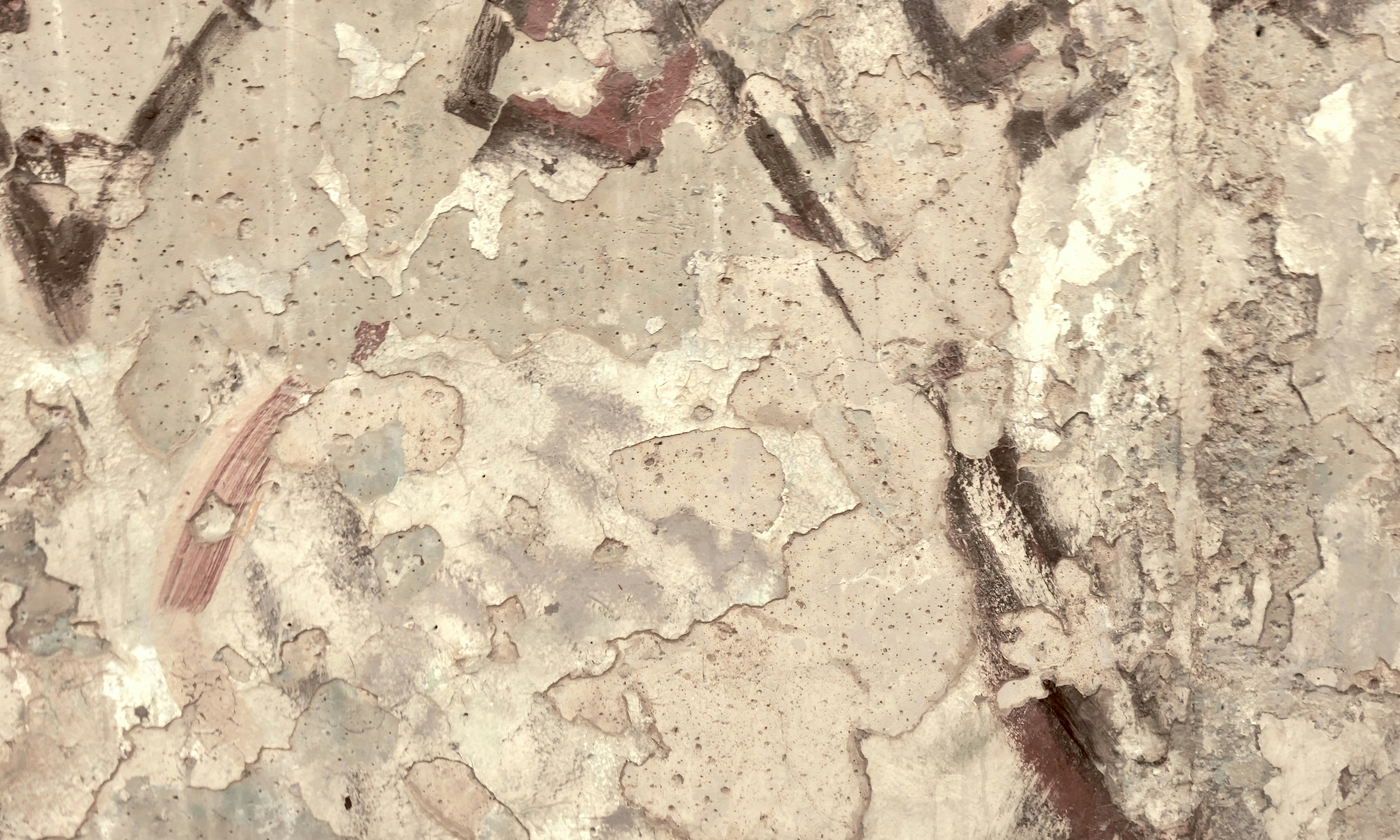 Damaged ancient artwork with peeling paint.