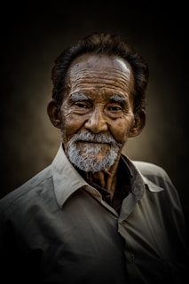 Smiling elderly man poses for a portrait.