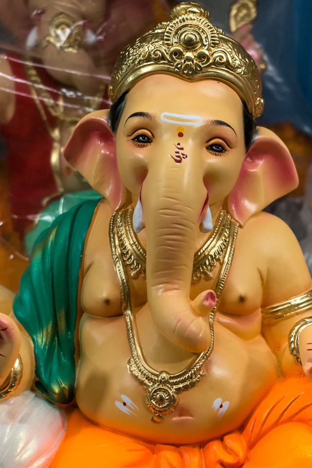 Close-up of a Ganesha idol adorned with a golden crown