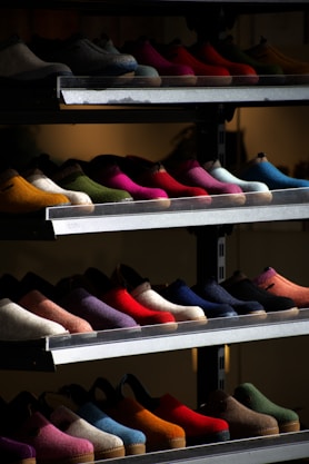 Shoes of many colors displayed on shelves.