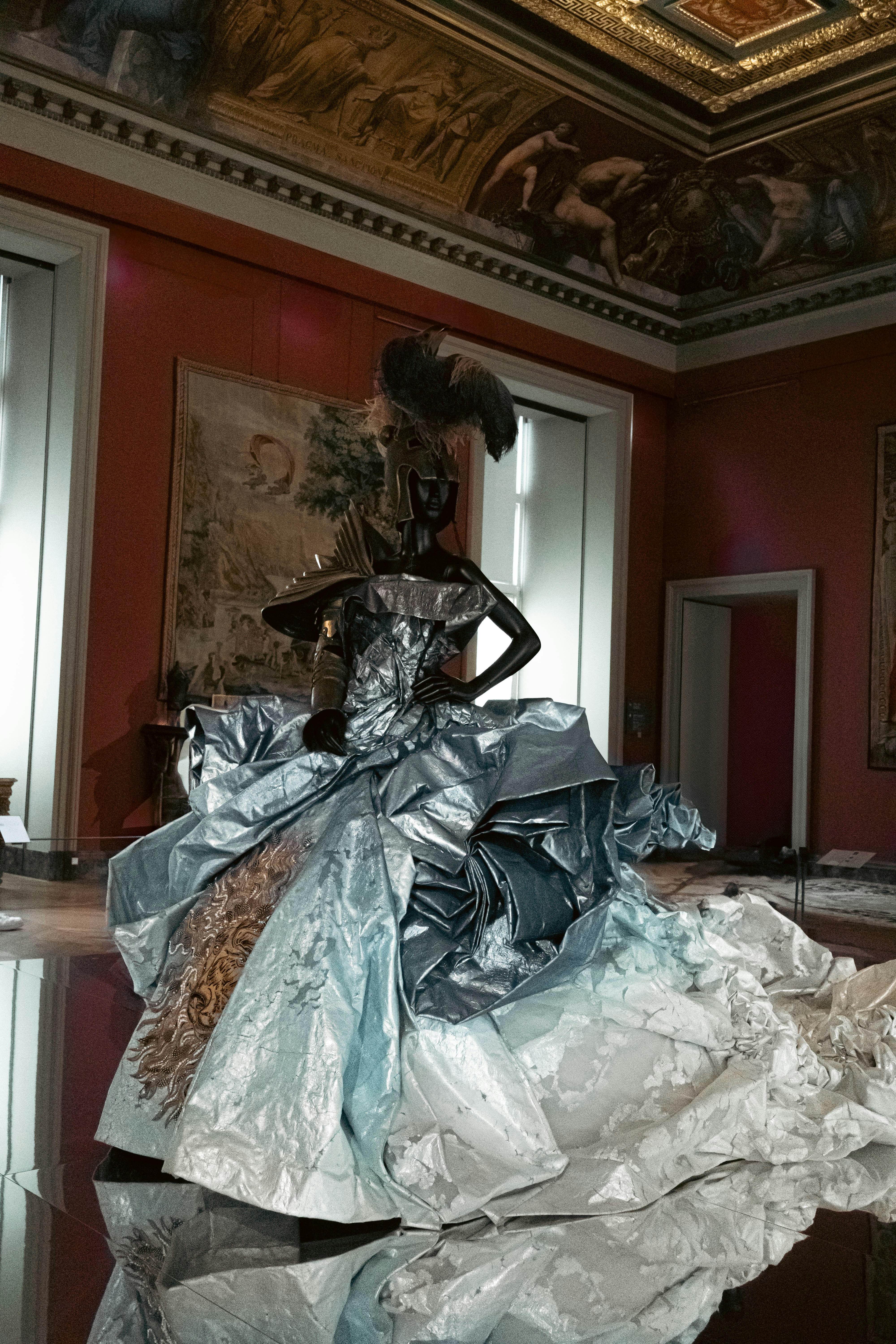 A dramatic fashion display in a regal room.