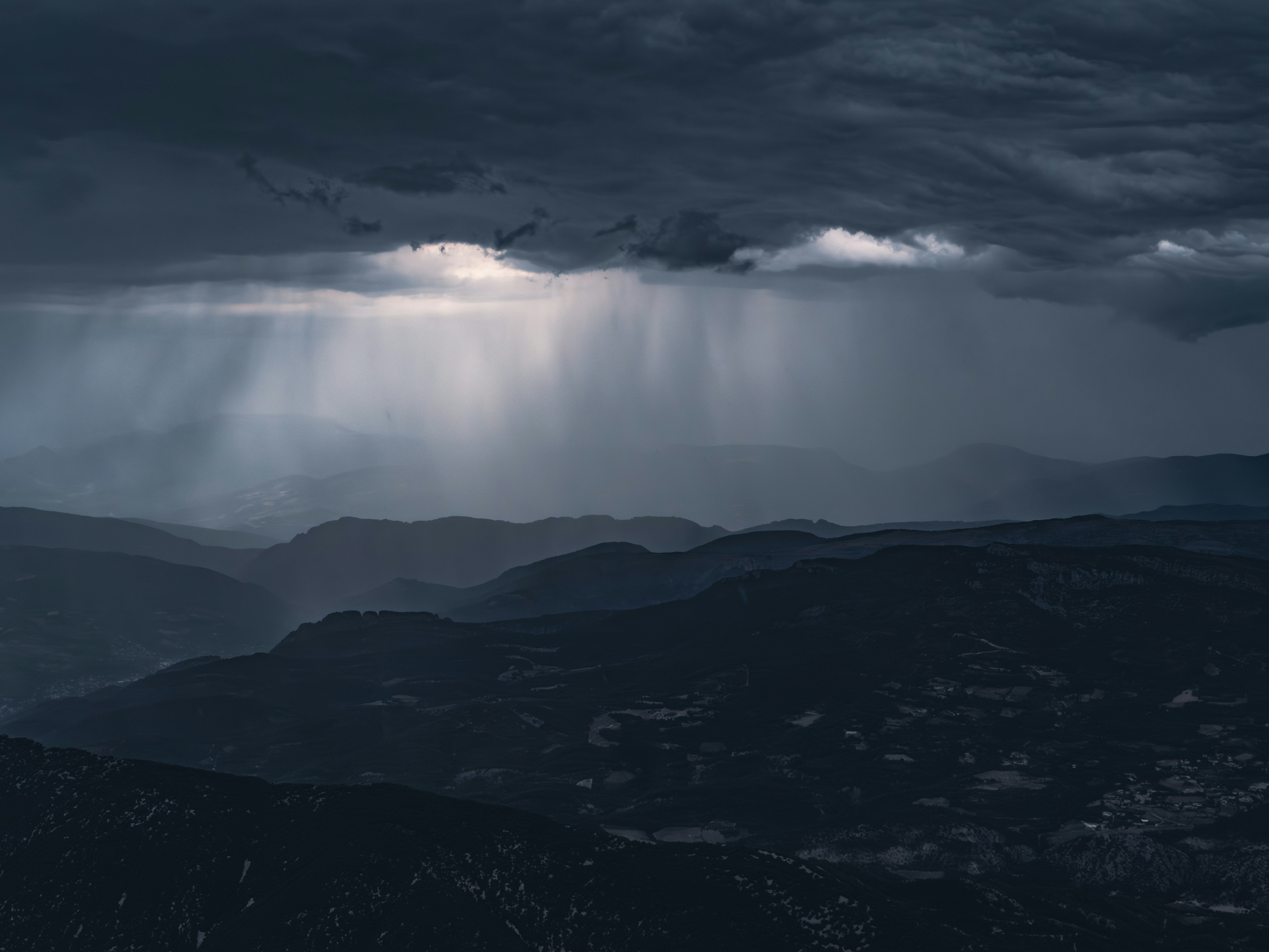 Rays of light pierce through the storm clouds.