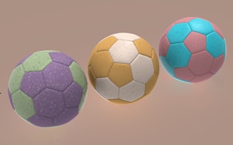 Three colorful soccer balls are displayed.