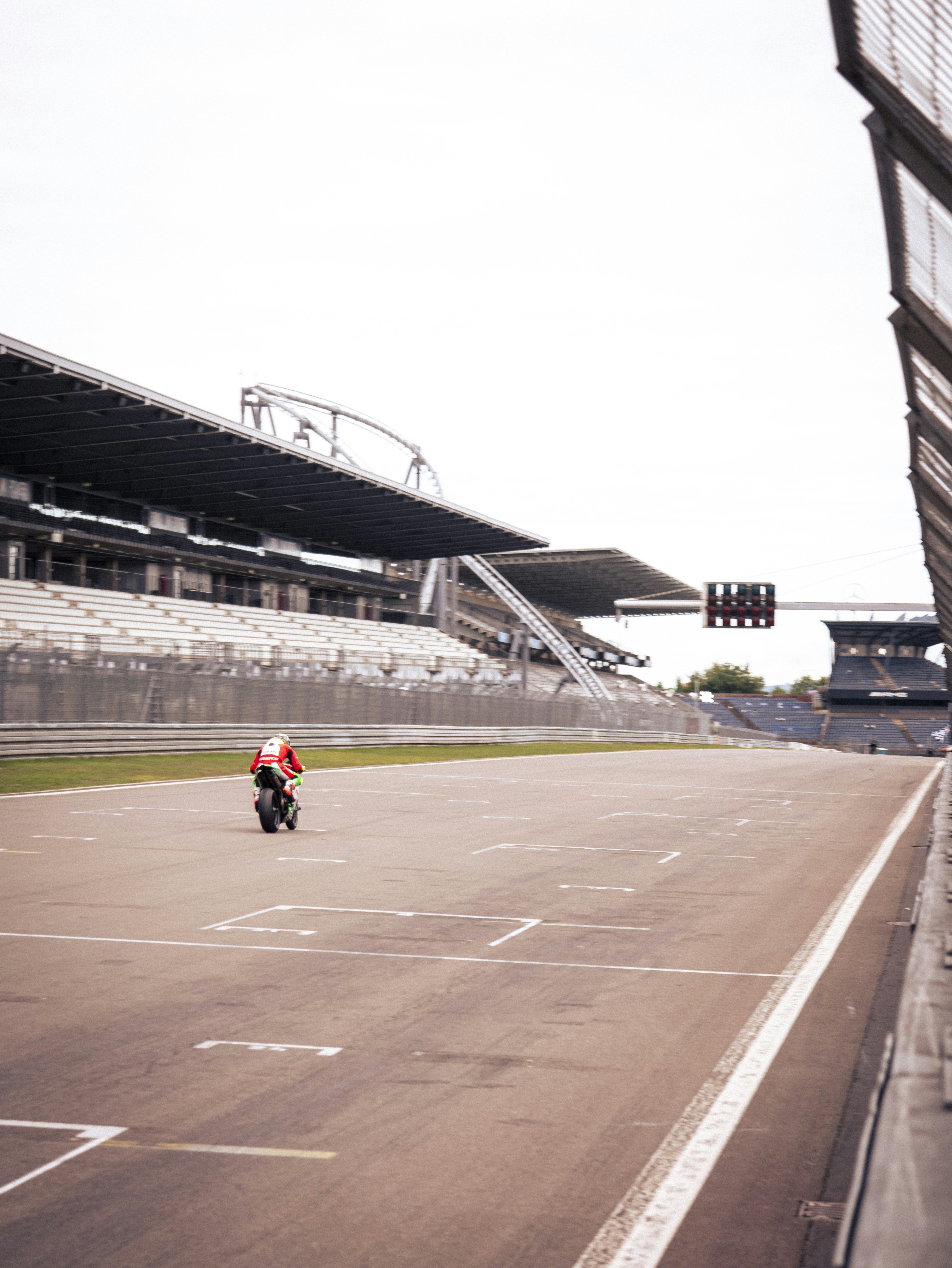 A motorcyclist rides solo on a race track.
