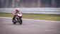 A motorcyclist races along a track