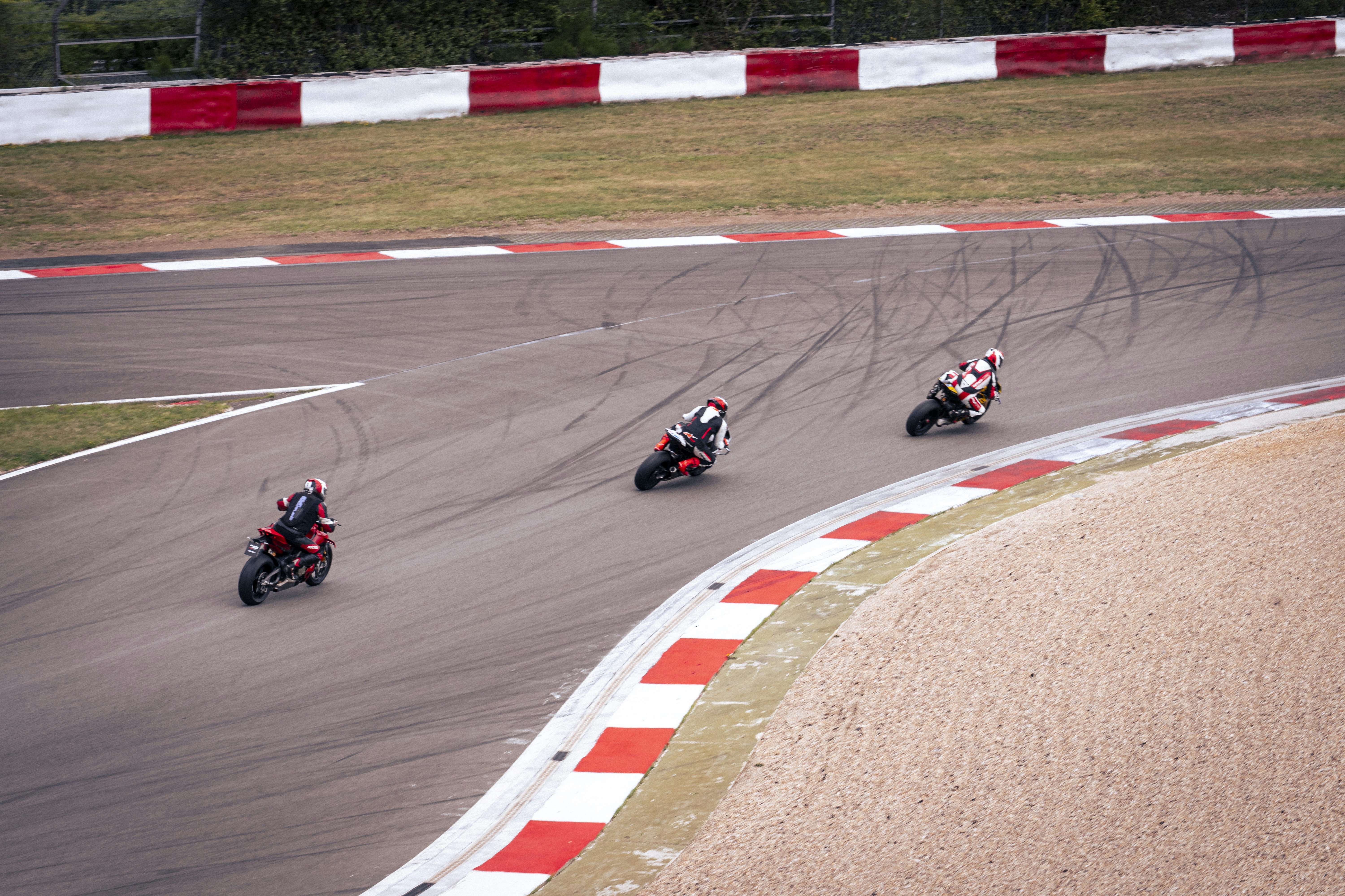 Motorcyclists race around a track's sharp curve. photo – Free Motorbike ...