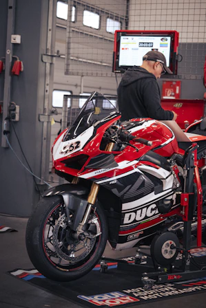 A motorcycle is being tested in a mechanic's shop.