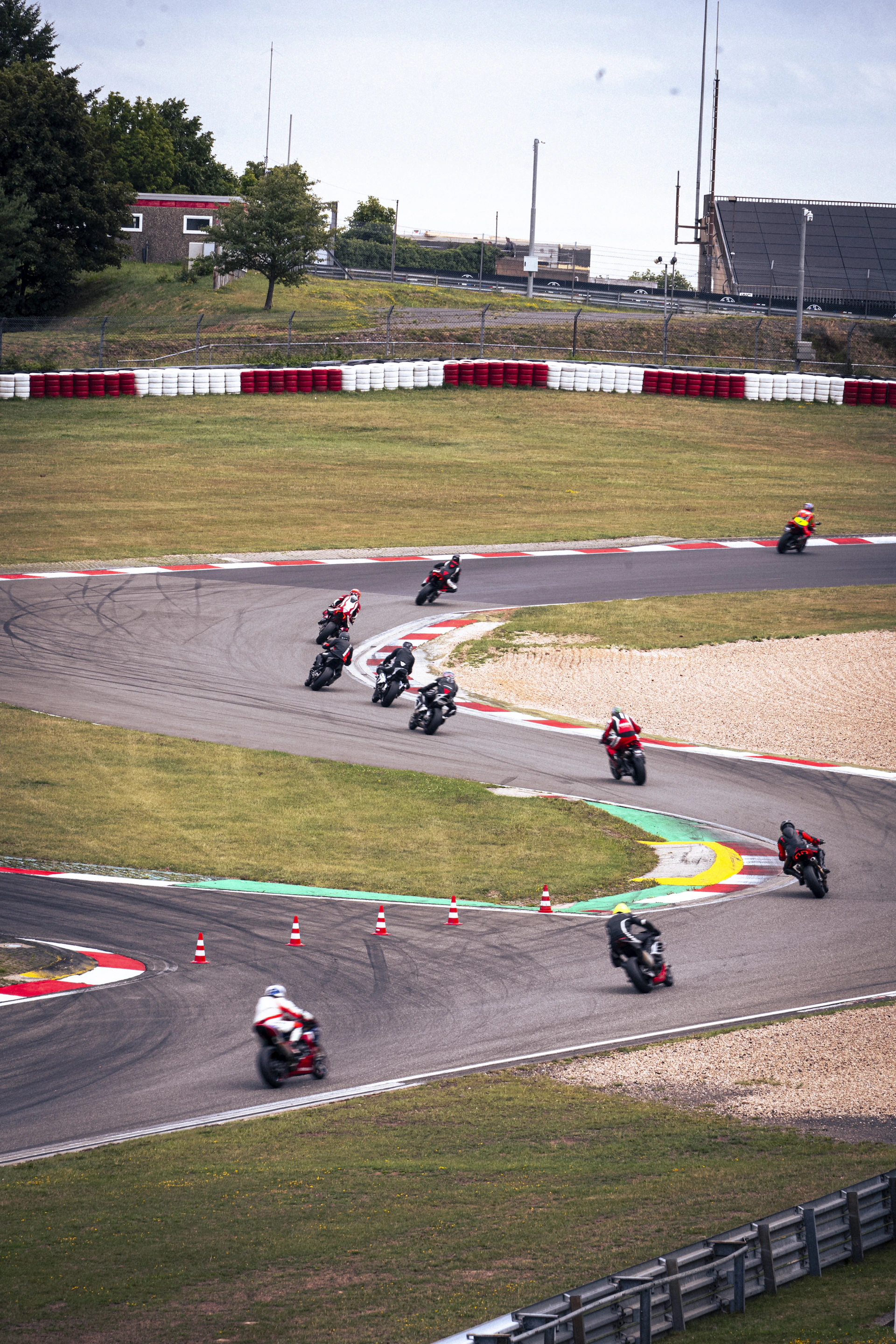 Motorcycles race around a curved racetrack.